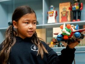 Young girl at Precious at Mouseum of Brisbane holding a toy plane