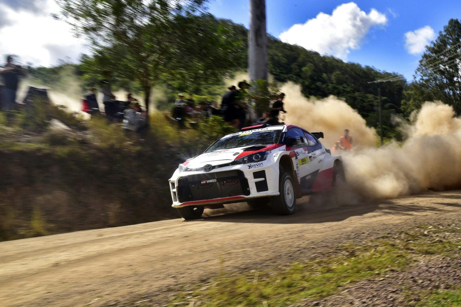 Rally car racing on gravel road