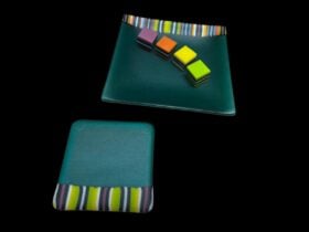 Glass coasters with trimming patterned like licorice all-sorts.