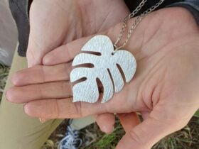 A metal necklace shaped like a leaf.
