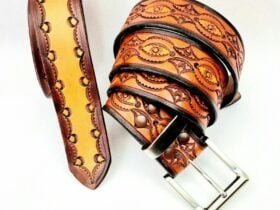 A rolled up leather belt with an intricate design.