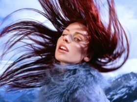 Rose Gray - a woman flicking her head back, her hair is flowing around her head