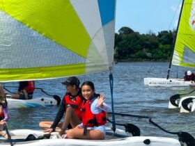 Child waving on a Sail boat