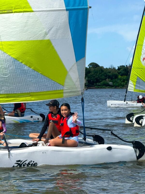Child waving on a Sail boat