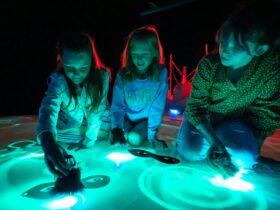 Young kids playing with light installations