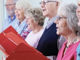 people with music books singing