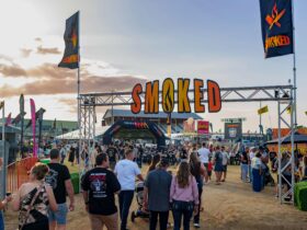 Smoked Festival sign with people walking underneath it