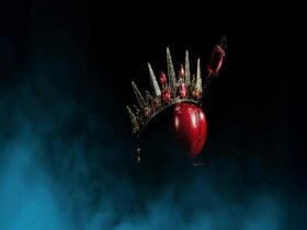 A red apple with a crown and dagger in it. Ballet Theatre Queensland Snow White.