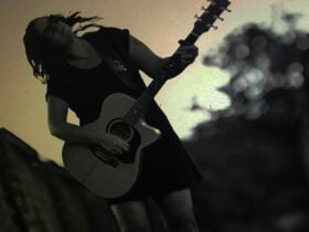 Amanda Emblem playing guitar