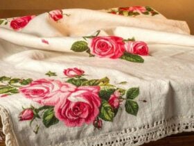A white tablecloth with a design of pink roses.