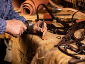 Close up of artisan carrying out leather-work