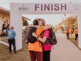 Trek the Trail Finish Line Photo - Two Attendees Embracing in Happiness