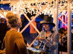 Two women talking at the Eats & Treats at the West End Christmas Twilight Markets