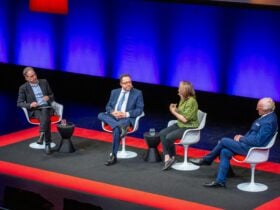 Four individuals sit on stage during a conversation event at QPAC