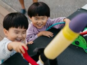 2 young children engaging with foam flying rocket