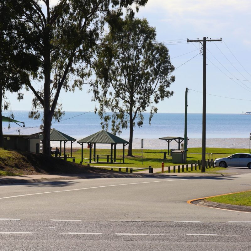 The bright blue southern bayside can be seen through the trees from the Pantry