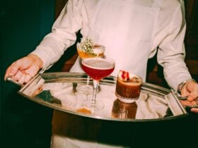 A silver tray with two lovely cocktails on it