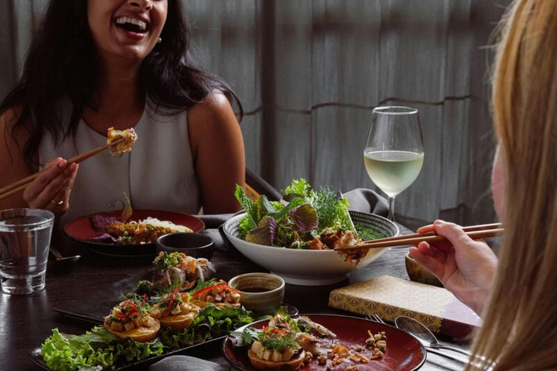 people laughing and eating at fat noodle