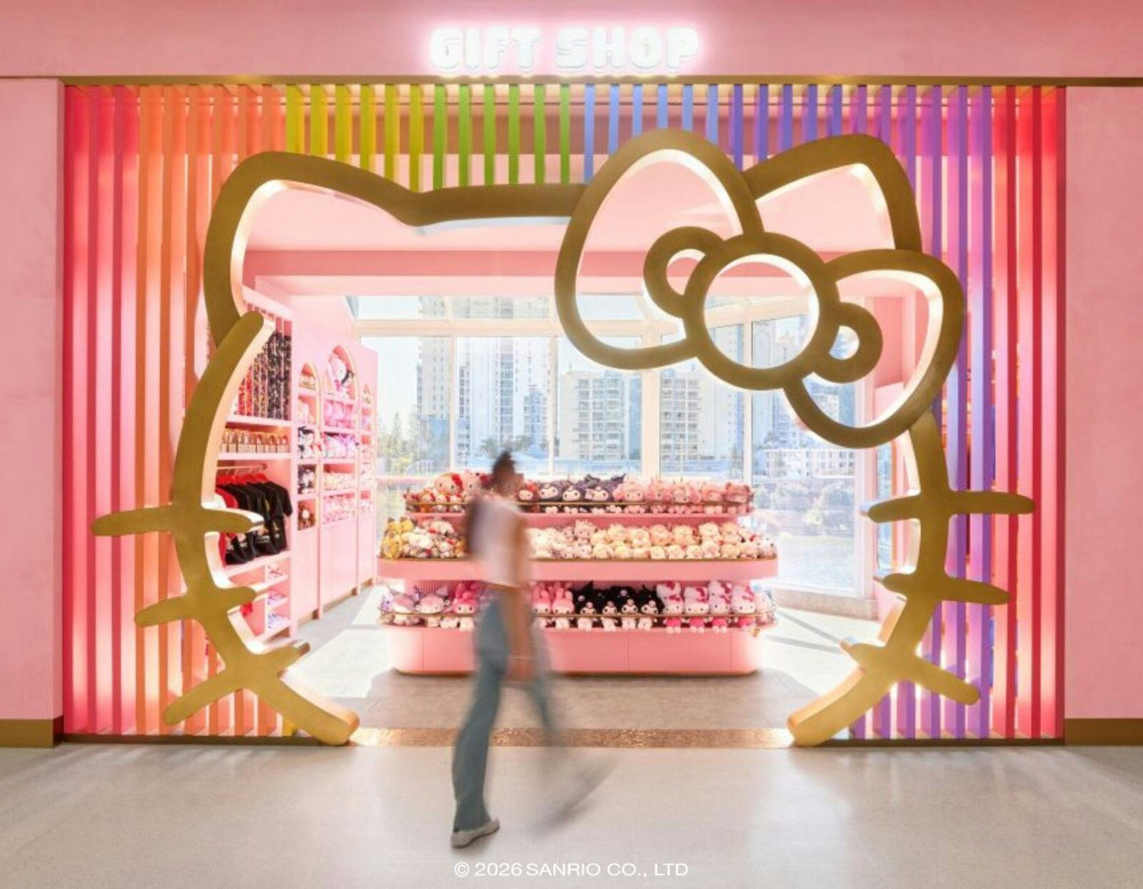 A retail entrance framed by a large Hello Kitty silhouette with pink interior.