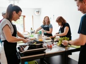 People cooking around a bench