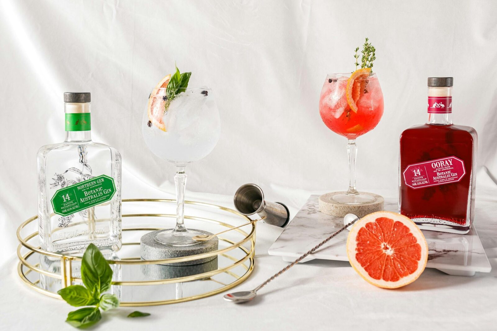 Gin bottles and cocktails with citrus garnish at Mt Uncle Distillery