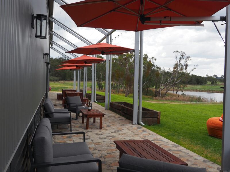 Outdoor seating looking over beautiful lawn space and estate vineyards