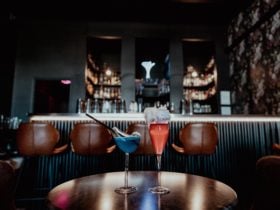 Three cocktails in front of the bar