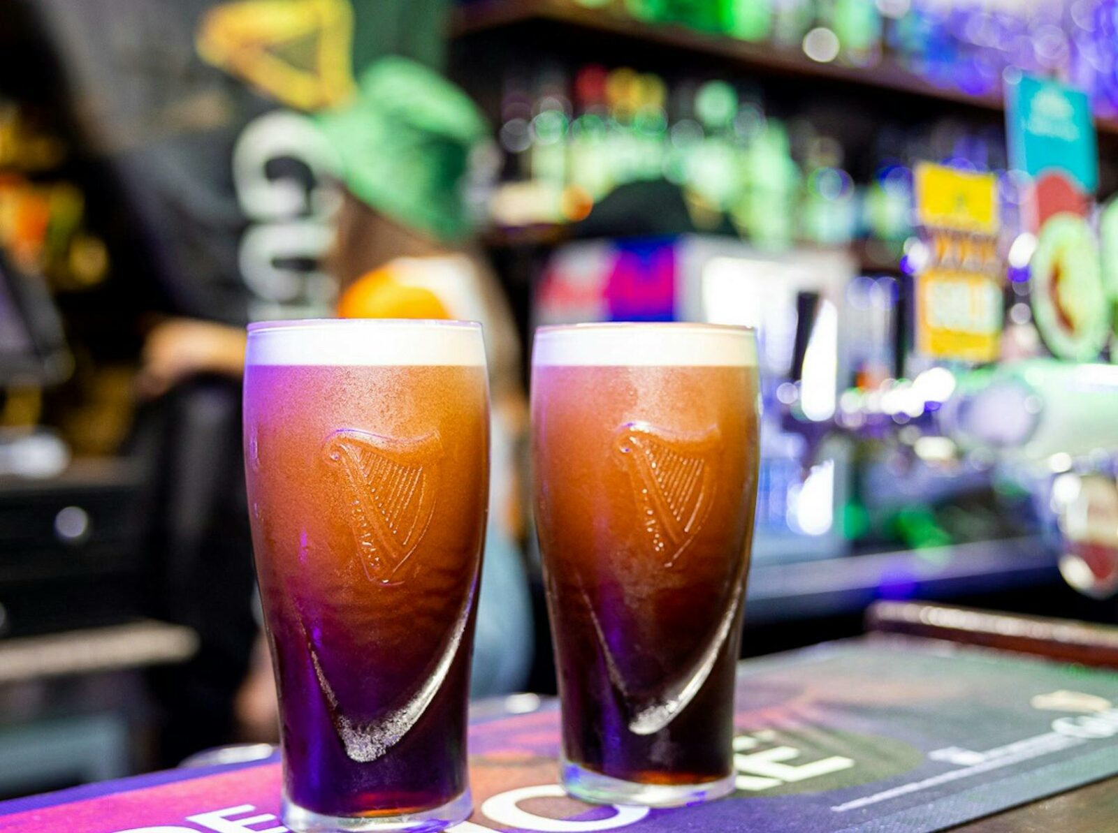 Two pints of Guinness on the top of the bar