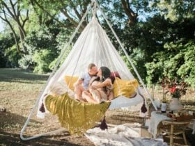 A couple enjoying a romantic picnic in a hanging tiipii pod at Soul Nook