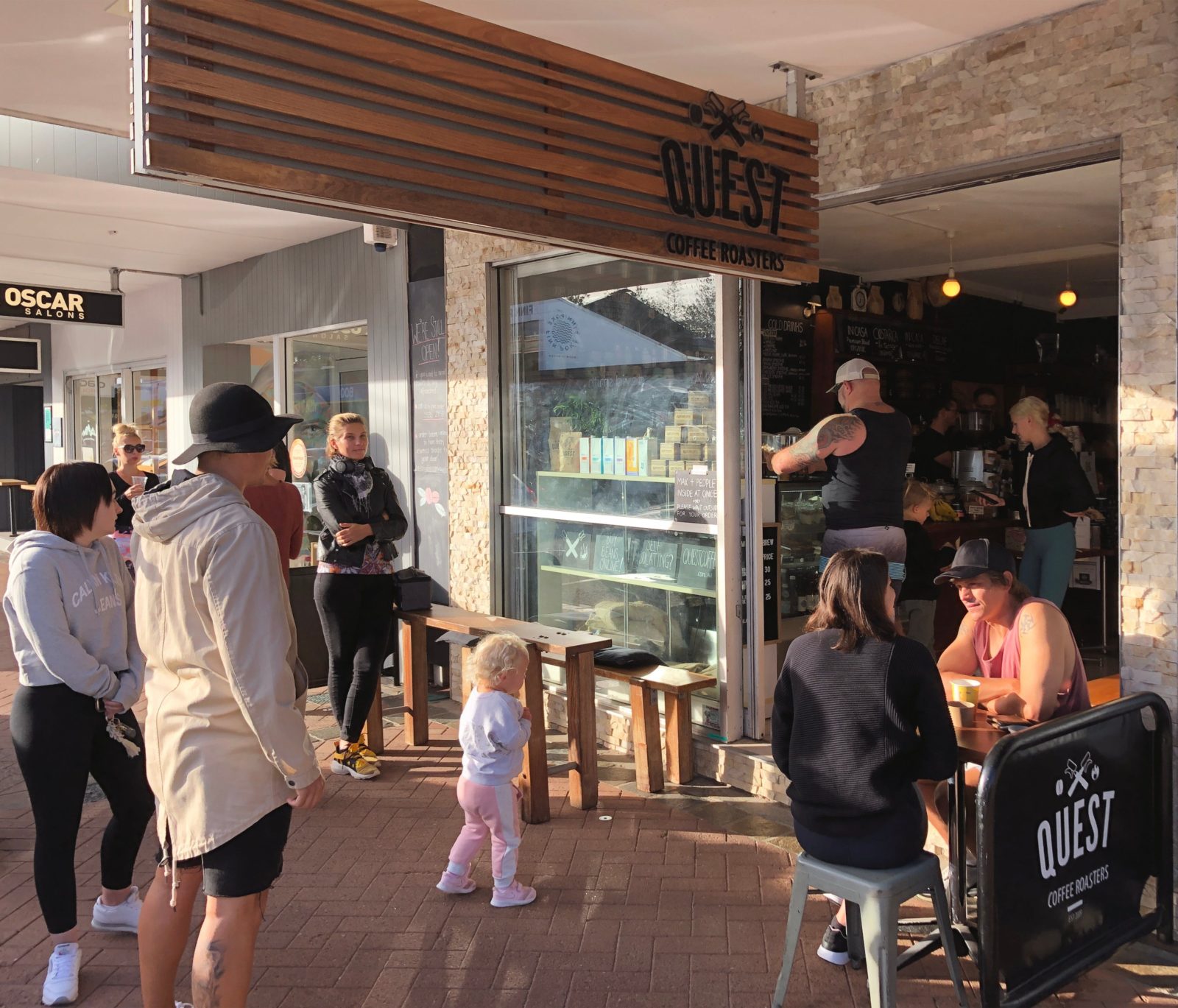 People awaiting drink and food orders at Quest Burleigh Cafe