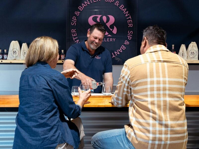 People sitting at a bar drinking gin