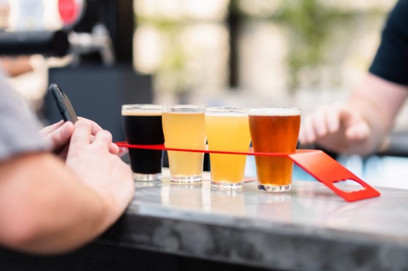 Selection of 4 tap beers on a tasting paddle at Slipstream Brewing.