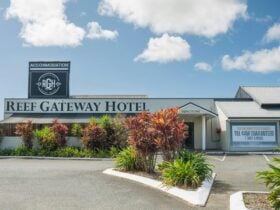 Front entrance to Reef Gateway Hotel with a large parking space