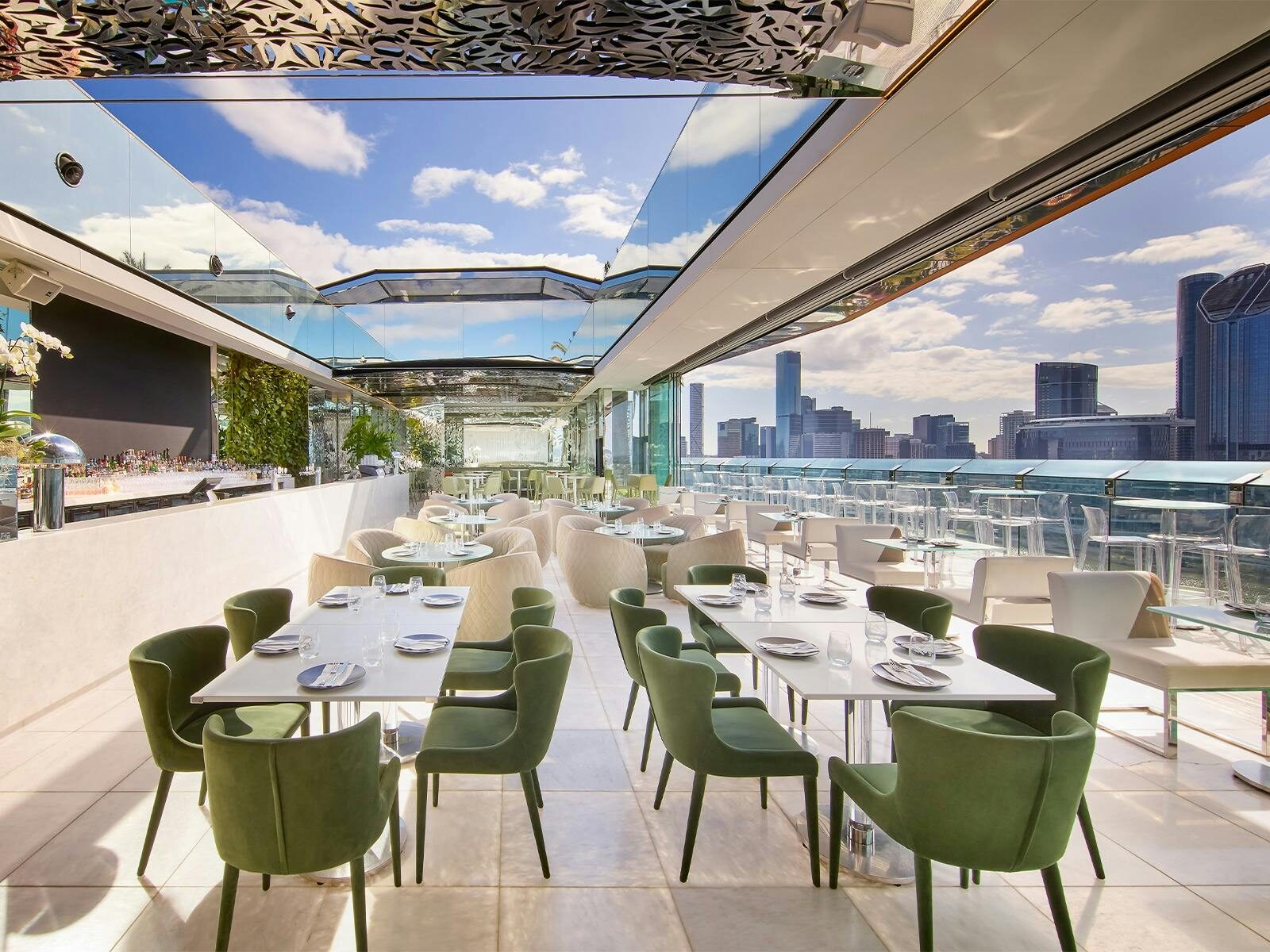 Rooftop bar with open roof and various furniture