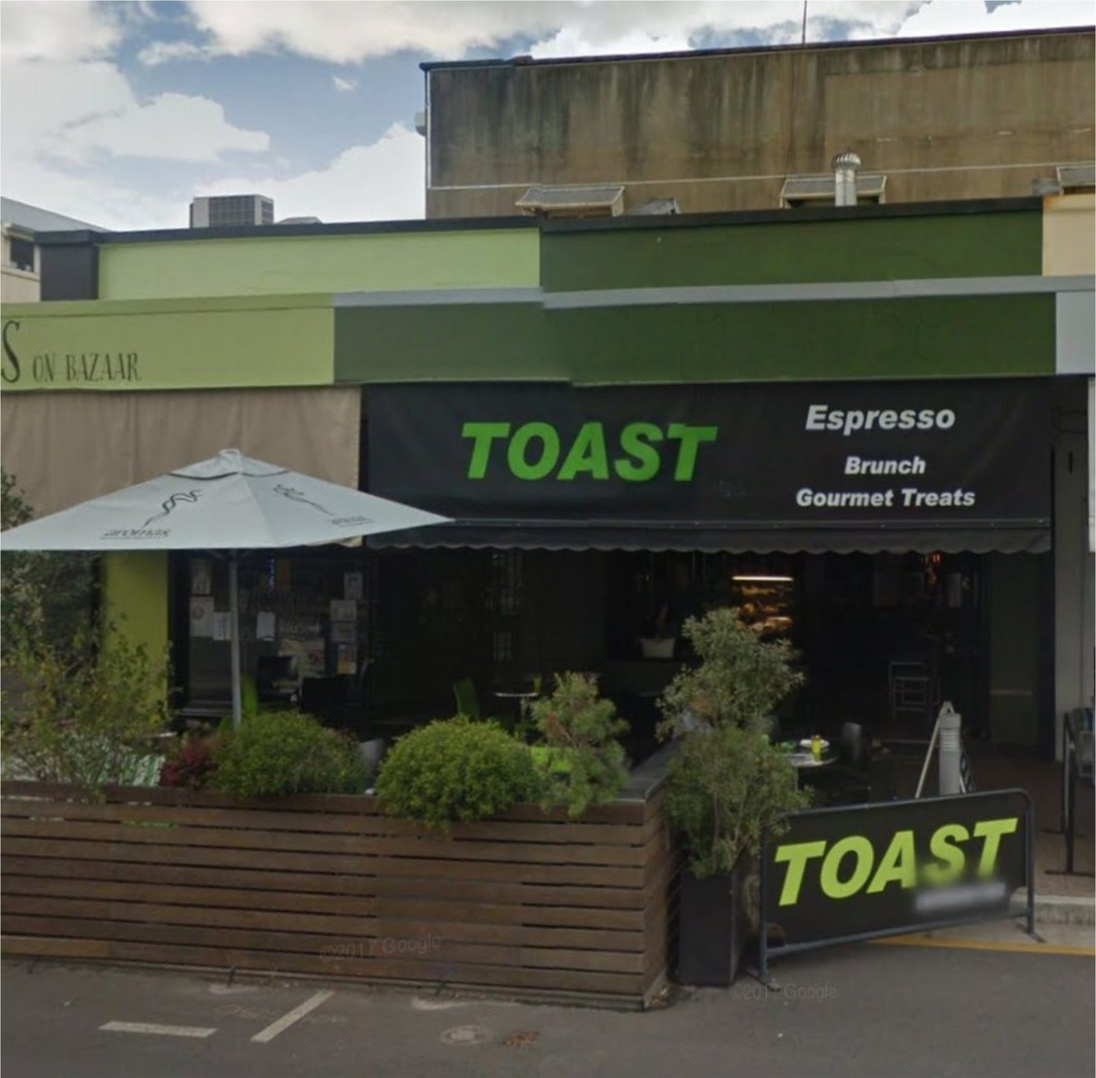 photo showing the faced of Toast Espresso bar with its outdoor seating on the street side