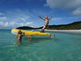 Kids having fun Whitehaven Beach swimming tender
