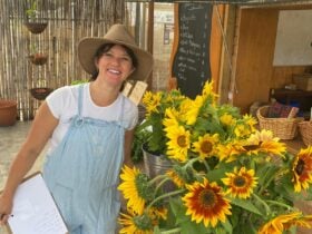 Lady standing with sunflowers