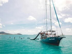 A photo of Atlantic Clipper with two waterslides and people paddleboarding