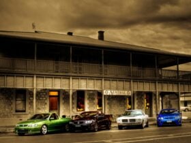 A view of The Austral Inn Hotel with four cars parked in front of the venue