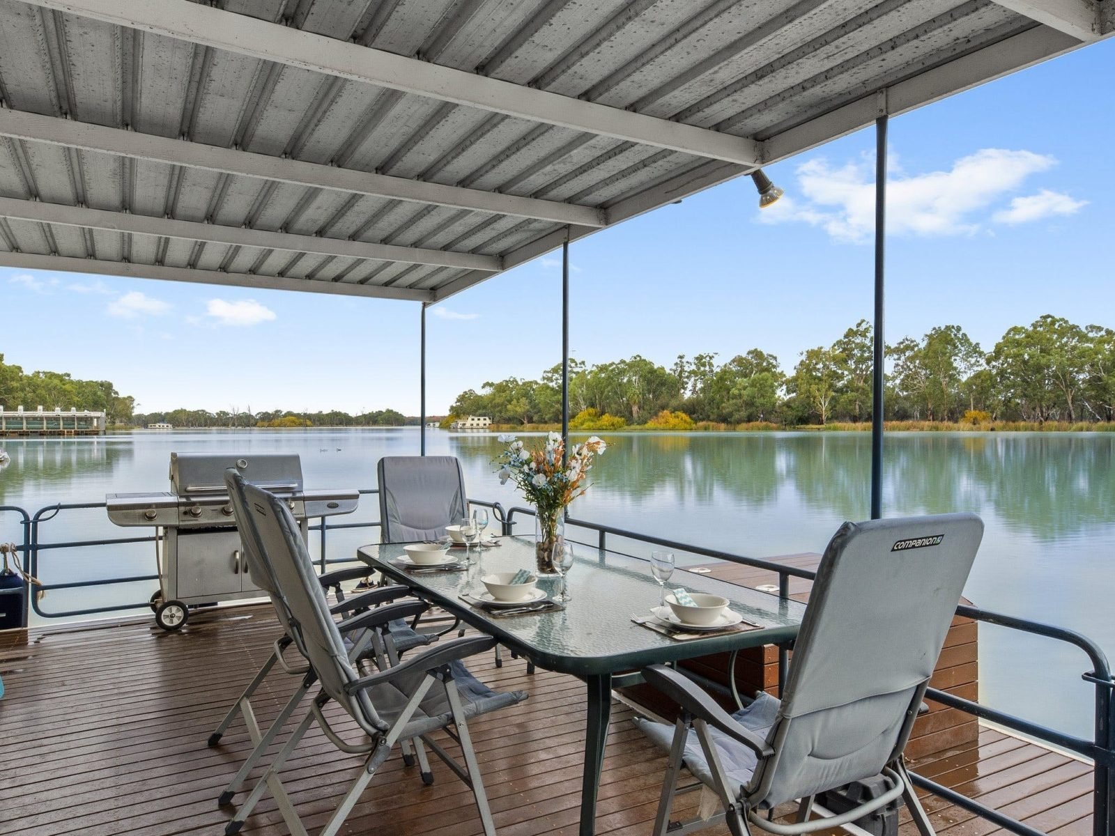 Spacious undercover outdoor dining area and hooded bbq