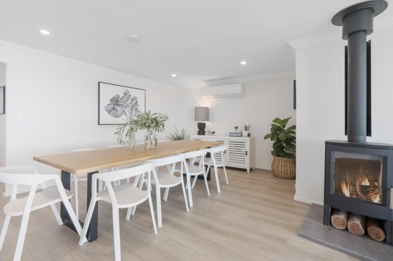 Newly renovated the home features an open living area with feature wood fire