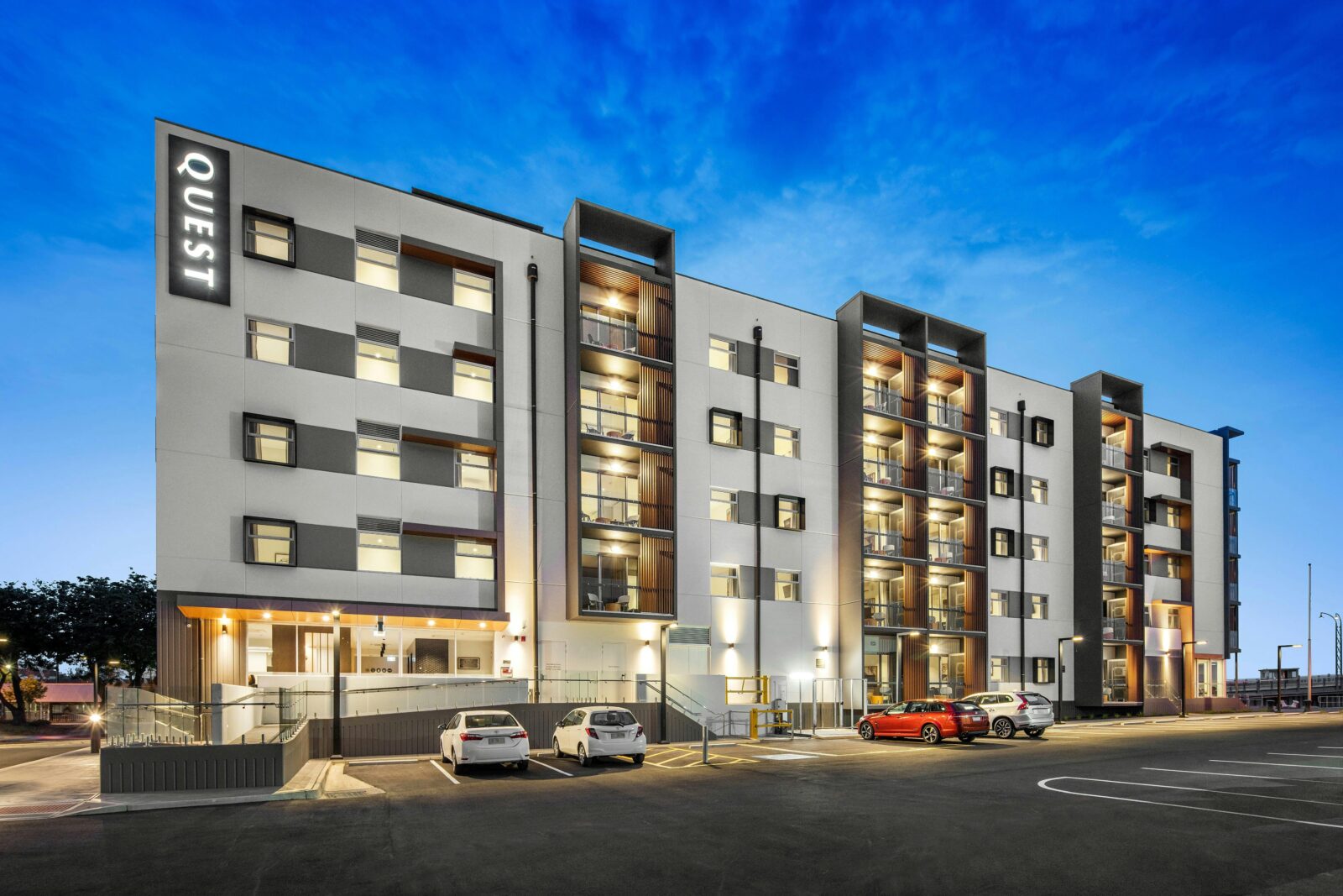 external photo of the hotel apartment building with an evening sky