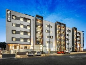 external photo of the hotel apartment building with an evening sky