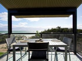Ocean view balcony with 4 seater dining and privacy blind