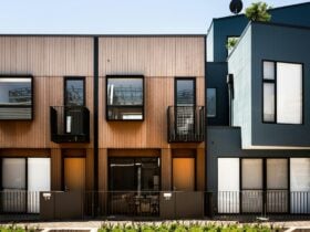 Modern suburban building facade with balconies, on a sunny day.