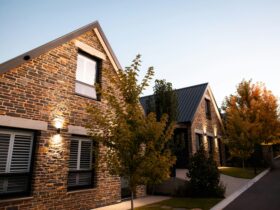 Stone cottages with trees with autumn color in foreground taken at dusk