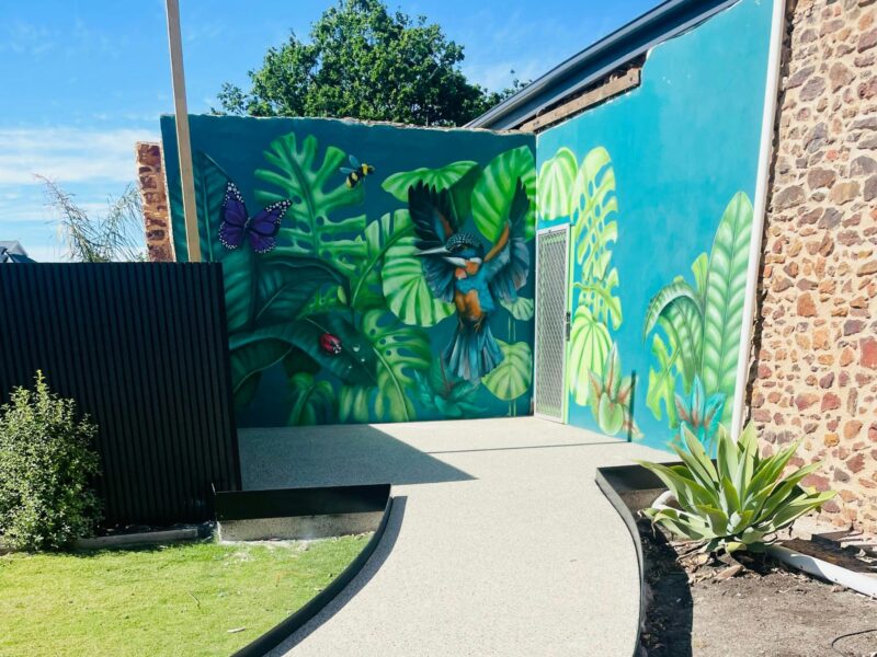Large green wall mural on building