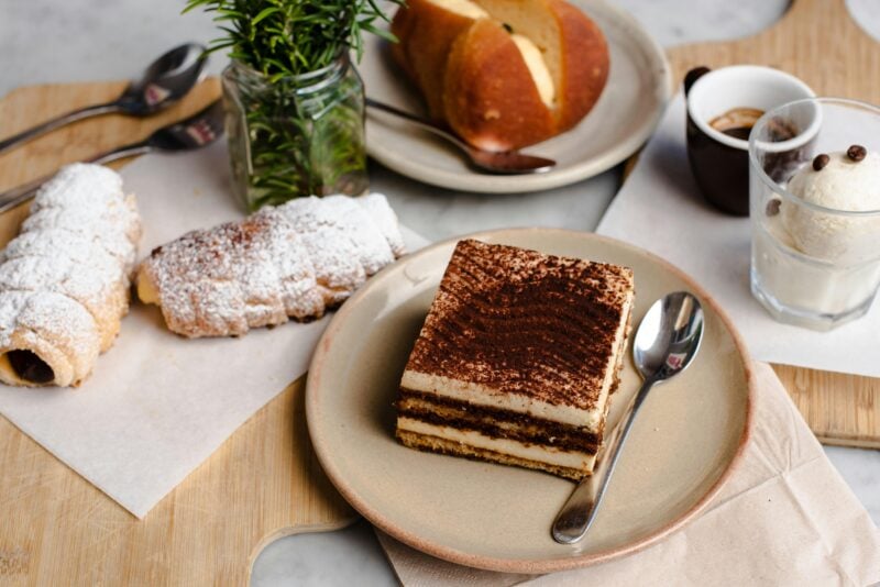 A serve of Tiramisu, some Italian pastries and a coffee
