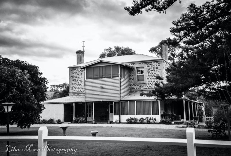 1842 stone homestead with lawn infront.