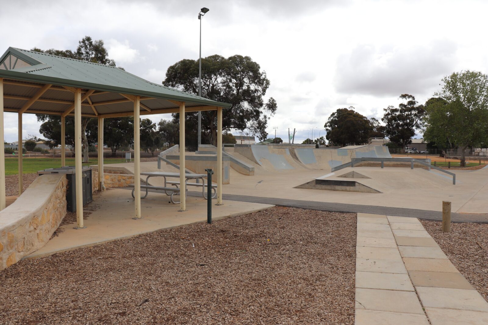 The nearby shelter contains seating and barbecue facilities.